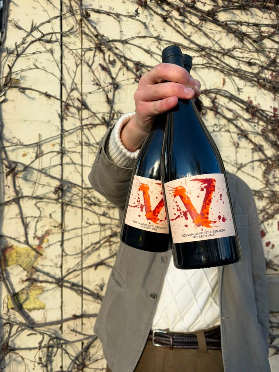 Morgan Payne holding up the wines in front of him